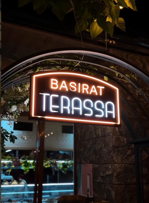 Basirat Terassa вЂ” neon sign and outdoor dining entrance at night