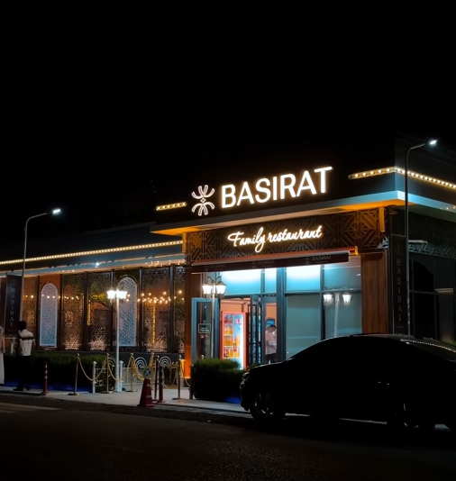 Basirat Family Restaurant exterior at night вЂ” illuminated sign and elegant facade